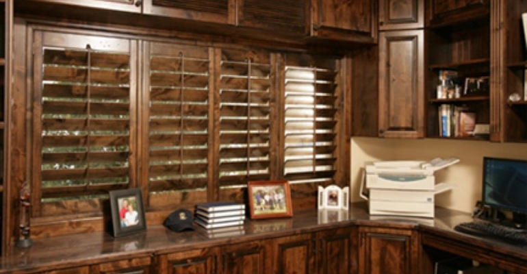  Dark wood shutters in home office.